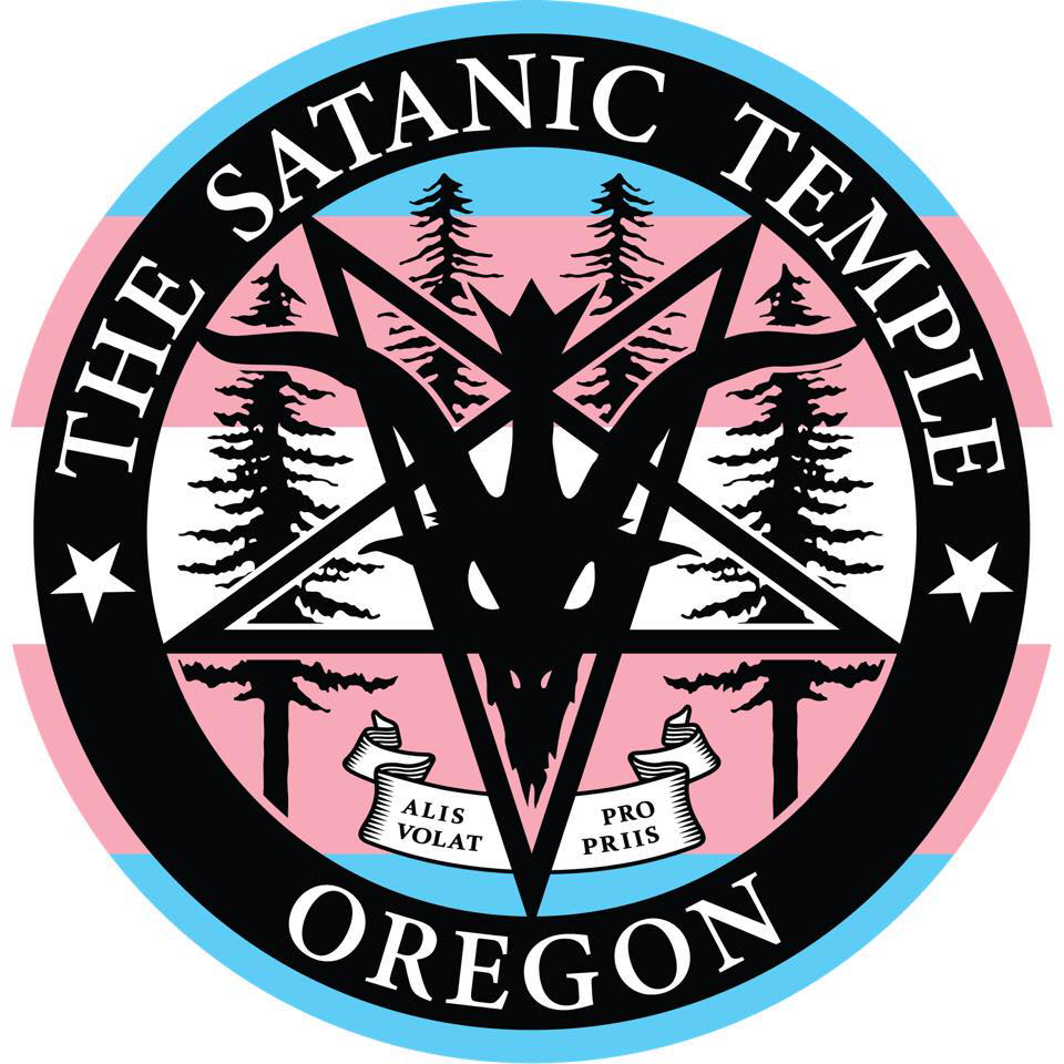 The TST Oregon logo in black, with the colors of the trans flag for the background
